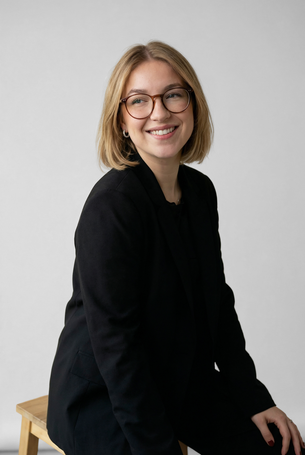 Detail of zipper pull with tan leather and silver rivet.